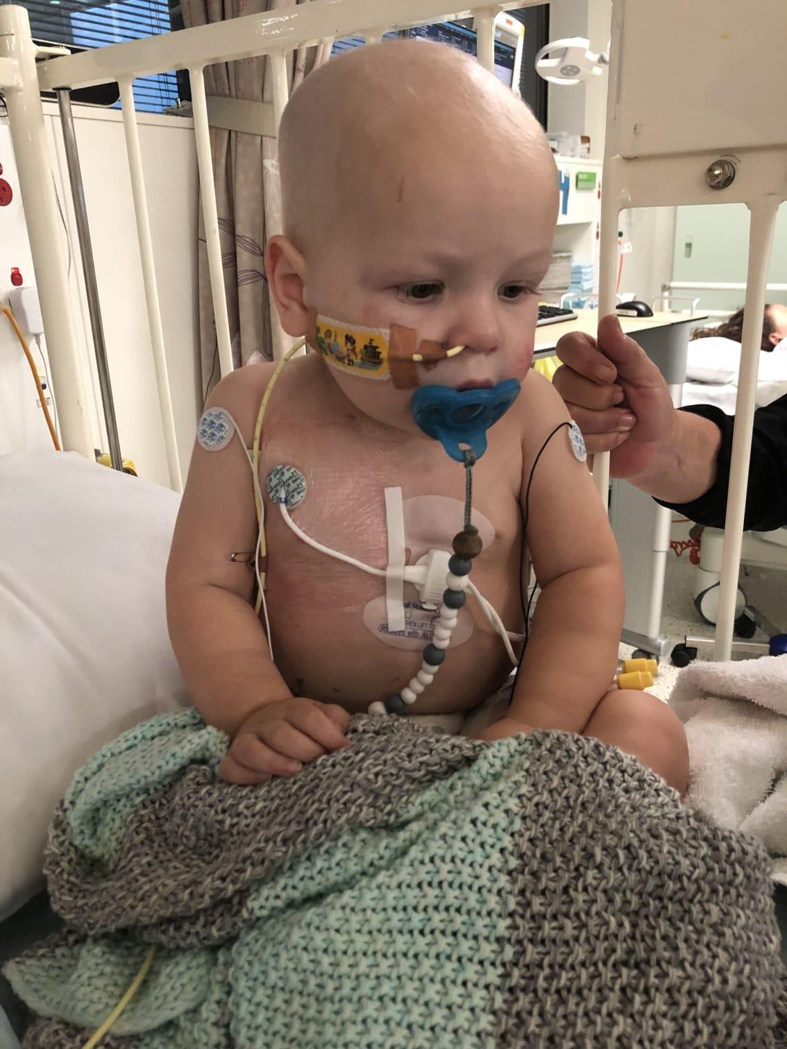 Georgie sitting in his hospital bed